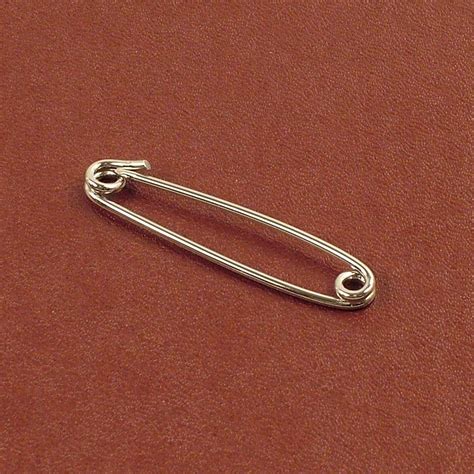 silver safety pin which can be used to pierce the collar