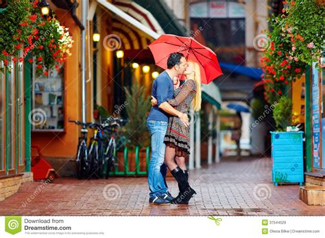 Happy Couple In Love Kissing On Rainy Street Royalty Free