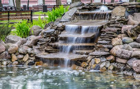 artificial waterfall   park stock photo  crus