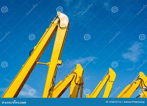 yellow backhoe  hydraulic piston arm  clear blue sky heavy machine  excavation
