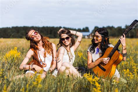 Three Cute Hippie Girl Sitting On Grass Outdoors Best Friends Having
