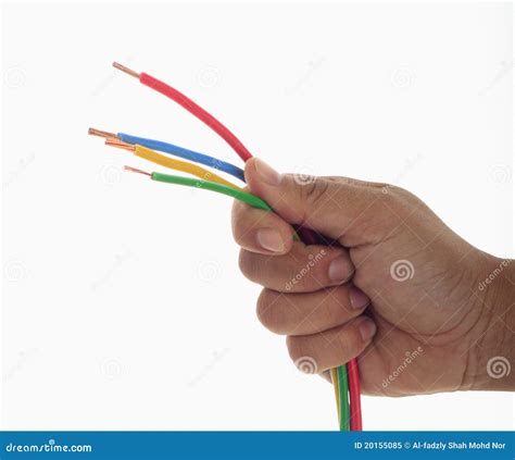 mans hand holding  electrical wire royalty  stock photo image