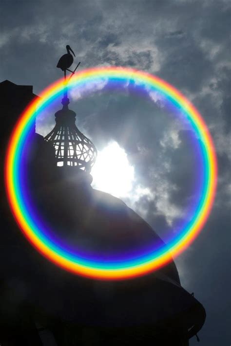 a rainbow around the sun above the lampoon building at