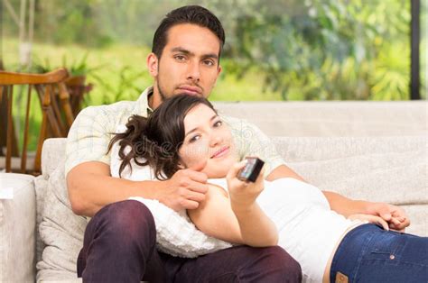 cute couple lying on the sofa watching tv and stock image image of