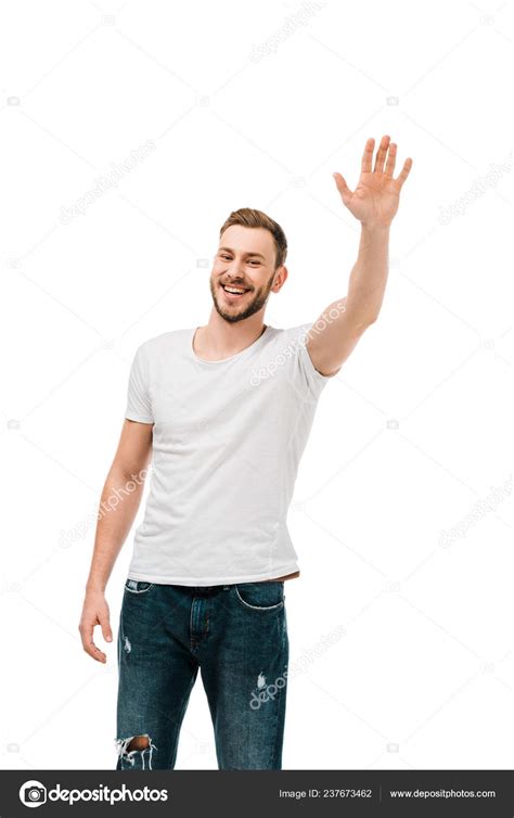 handsome happy young man waving hand smiling camera isolated white