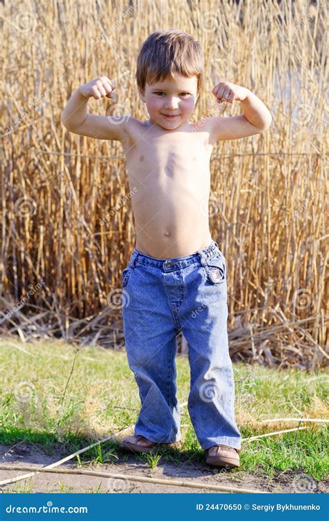 strong kid showing  muscles stock photo image  smiling cheerful