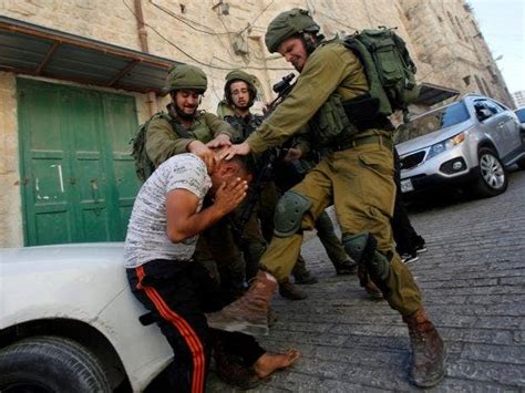 israeli soldiers photographed beating palestinian in west