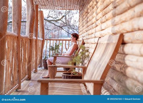 Woman Relaxes After Sauna In A Wooden Log Cabin In Winter Stock Image