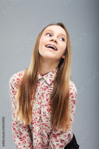 beautiful caucasian blonde girl with braces laughing buy this stock
