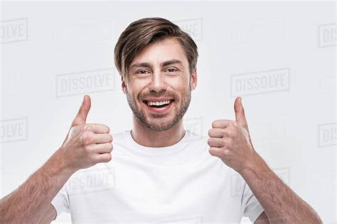 handsome smiling man showing thumbs  isolated  white stock photo