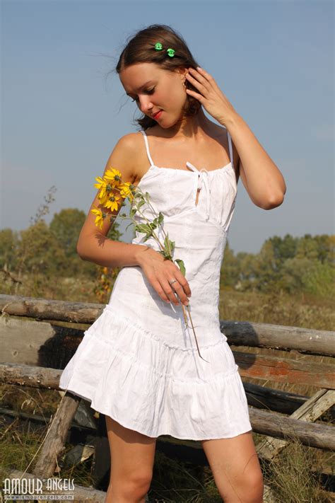 attractive gal plays with her neat white dress while