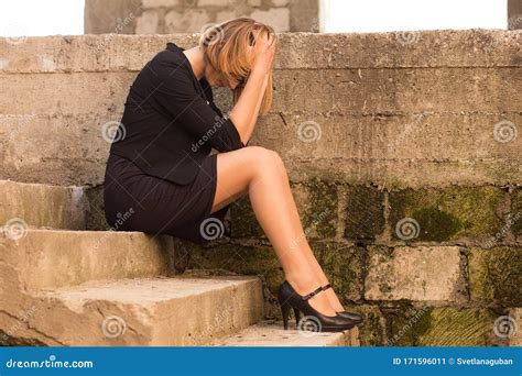 Sad Woman Sitting On The Stairs Of An Abandoned Building Upset Lonely
