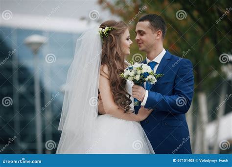 Gorgeous Happy Brunette Bride And Elegant Groom In Blue Suit On Stock