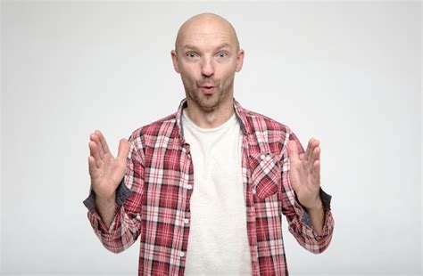 Premium Photo Amazed Shocked Bald Man Showing Huge Size Gesture With