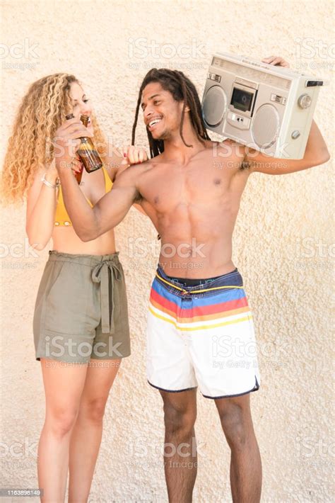Africanamerican Watching His Beer While His Blonde Girlfriend Sees Him