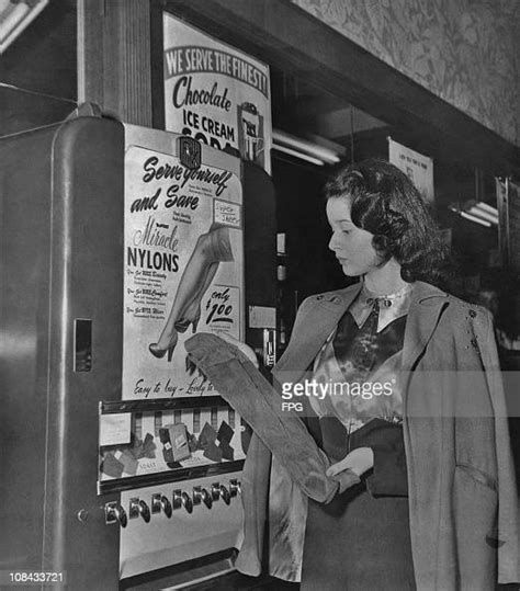 a woman buying a pair of nylons from a street vending machine circa