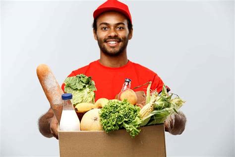delivery concept handsome african american delivery man carrying package box  grocery food