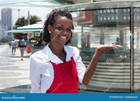 Cheerful African American Waitress In Front Of The Restaurant Stock