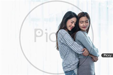 Image Of Two Asian Lesbian Women Hug And Embracing Together In Bedroom