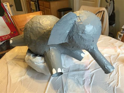 elephant statue sitting  top   table covered  plastic wrap