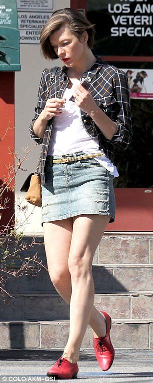 Milla Jovovich Shows Off Her Legs In A Short Denim Skirt As She Takes
