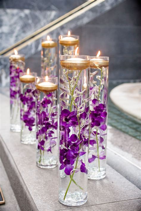 glass vases  purple orchids  floating candles