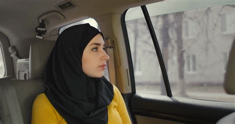 A Serious Thoughtful Arab Woman In A Car In The Passenger Seat Rides
