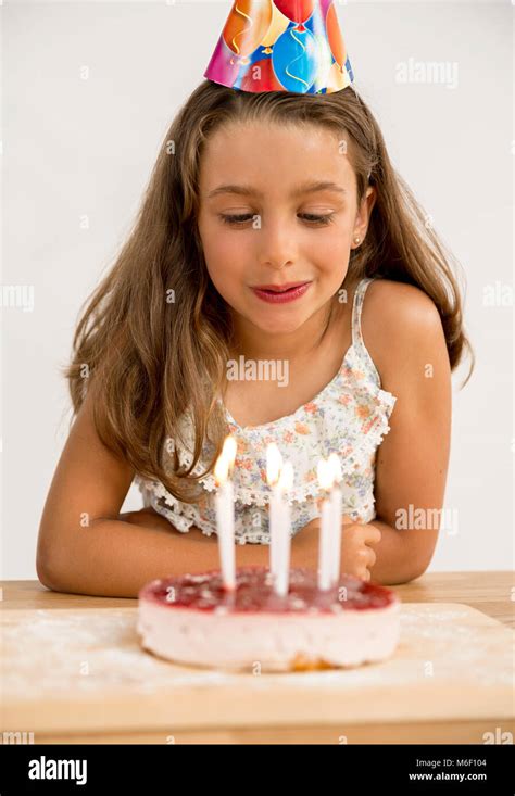 Shot Of A Young Girl Blowing Out The Candles On Her Birthday Cake Stock