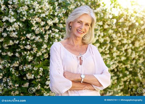 Older Woman Smiling And Standing Outside In Spring Stock Image Image