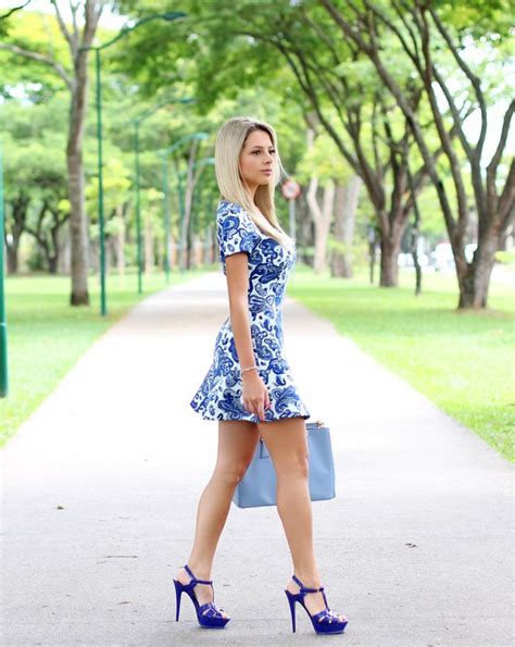 blonde cutie showing off her sexy legs in a short floral dress and strappy ysl high heels in a