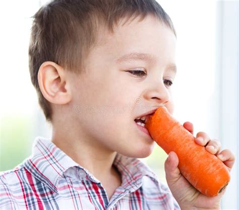 boy  eating carrot stock image image  hungry caucasian
