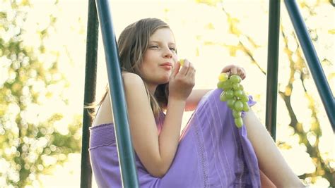 smiling preteen girl eating green stock footage video 100