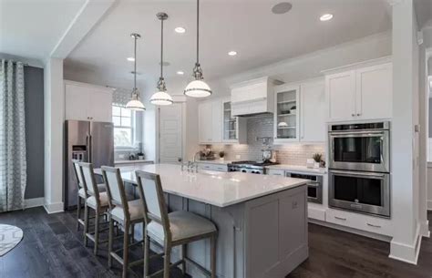 kitchen  white cabinets  gray counter tops  island   middle  surrounded