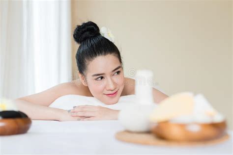 Young Beautiful Asian Woman Relaxing In The Spa Massage Stock Image