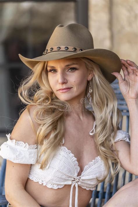 a lovely blonde model dressed as a cowgirl enjoys the american west