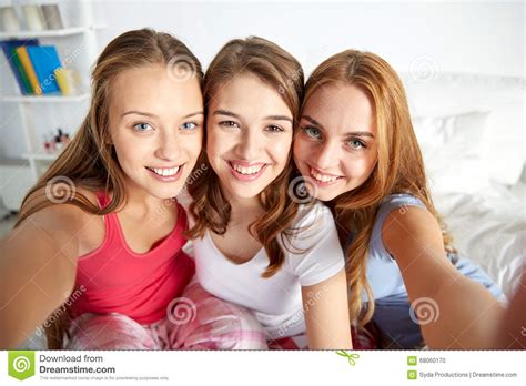 Happy Friends Or Teen Girls Taking Selfie At Home Stock