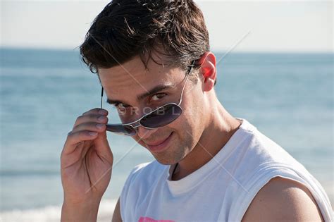 Man Lowering His Sunglasses At The Beach Rob Lang Images Licensing
