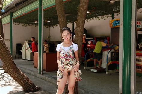 chinese female public flasher at amusement park flashing her hairy pussy gutteruncensored