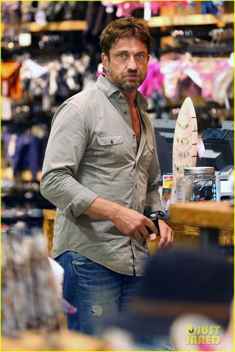gerard butler scopes out surf gear after kissing session with mystery