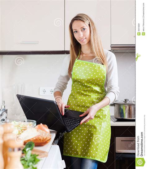 Smiling Woman In Apron Cooking With Notebook Stock Image