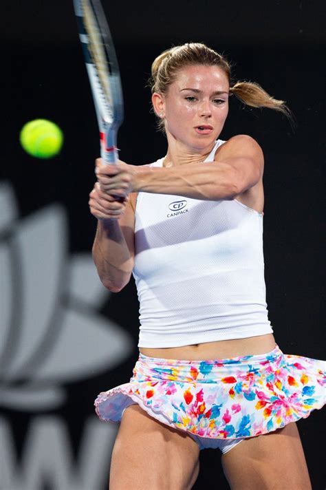 Female Tennis Player In White Shirt And Colorful Dress