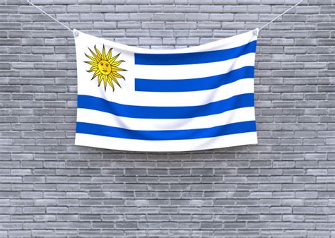 Bandera De Uruguay Colgando En La Pared De Ladrillo Foto