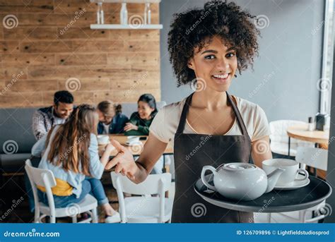 Smiling African American Waitress Holding Tray With Tea And Customers