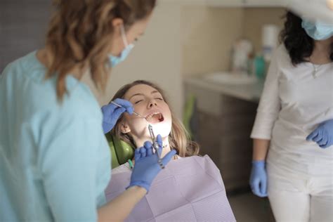young female dentist  injection  treating patient  clinic