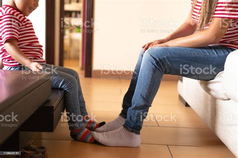 mom and son playing with their feet in the living room brothers joking