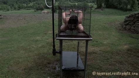 juliette march is outside in the cage getting sprayed with cold water