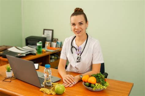 happy female dietitian  uniform  stethoscope  workplace stock