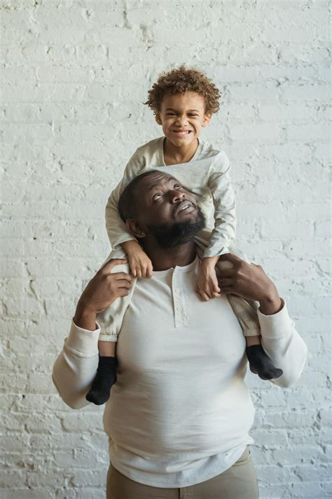 black father holding child  shoulders  stock photo