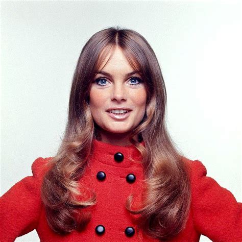 jean shrimpton is wearing a short red coat with mandarin collar by