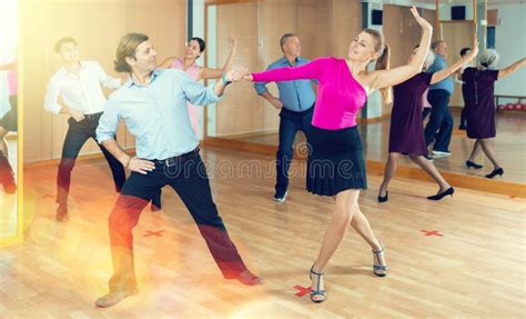 Adult Amateur Dancers Pair Practicing Swing In Dance Class Stock Image